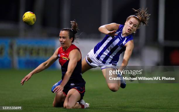 Daisy Pearce of the Demons smothers the kick of Emma Kearney of the Kangaroos during the 2021 AFLW Round 03 match between the Melbourne Demons and...