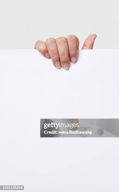 woman hand holding up the empty white a paper isolated with clipping path - hand holding card stock-fotos und bilder