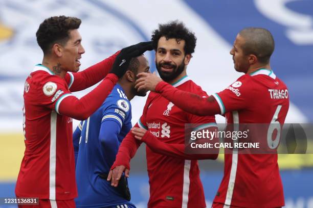 Liverpool's Egyptian midfielder Mohamed Salah celebrates with teammates after scoring his team's first goal during the English Premier League...