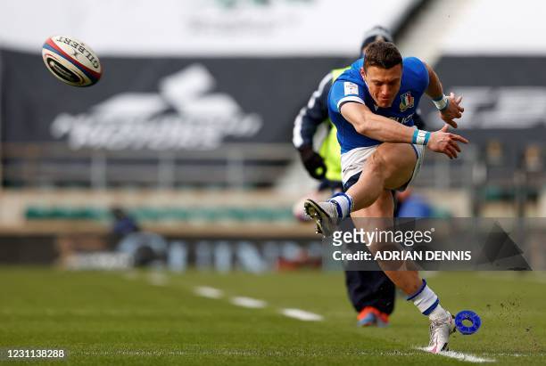 Italy's fly-half Paolo Garbisi kicks the ball but fails to convert the first try during the Six Nations international rugby union match between...