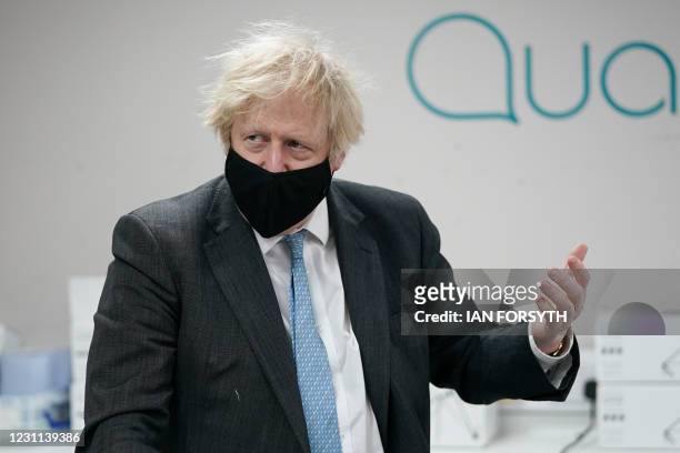 Britain's Prime Minister Boris Johnson wearing a face covering visits the QuantuMDx Biotechnology company in Newcastle upon Tyne, north east England,...