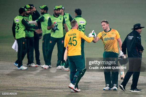 South Africa's captain Heinrich Klaasen celebrates with teammate David Miller after winning the match against Pakistan during the second T20...