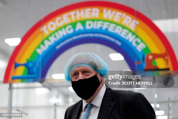 Britain's Prime Minister Boris Johnson , wearing a face mask and a hair net visits the Northumbria Healthcare NHS Trust personal protective equipment...