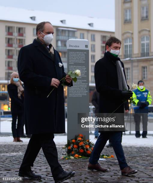 February 2021, Saxony, Dresden: Michael Kretschmer , Prime Minister of Saxony, and Dirk Hilbert , Lord Mayor of the City of Dresden, stand holding...