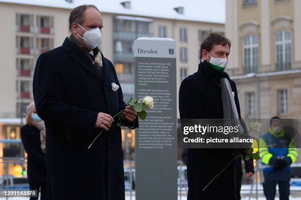 February 2021, Saxony, Dresden: Michael Kretschmer , Prime Minister of Saxony, and Dirk Hilbert , Lord Mayor of the City of Dresden, stand holding...