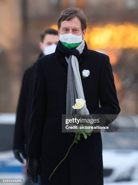 February 2021, Saxony, Dresden: Michael Kretschmer , Prime Minister of Saxony stands before a flower-laying ceremony on the 76th anniversary of the...