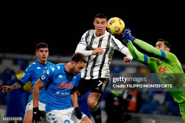 Napoli's Italian goalkeeper Alex Meret deflects a shot under pressure from Juventus' Portuguese forward Cristiano Ronaldo during the Italian Serie A...