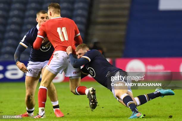 Wales' wing Liam Williams is tackled by Scotland's fly-half Finn Russell during the Six Nations international rugby union match between Scotland and...