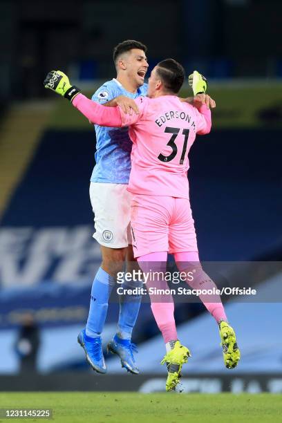 Rodri of Manchester City congratulates Manchester City goalkeeper Ederson aftere his assist set up their 3rd goal during the Premier League match...
