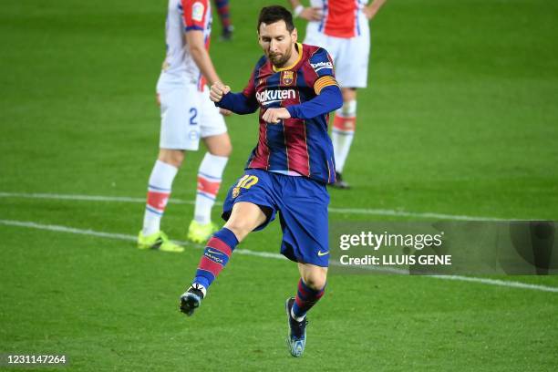 Barcelona's Argentinian forward Lionel Messi celebrates after scoring a goal during the Spanish League football match between FC Barcelona and...