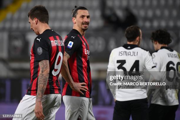 Milan's Swedish forward Zlatan Ibrahimovic and AC Milan's Croatrian forward Mario Mandzukic l react during the Italian Serie A football match Spezia...