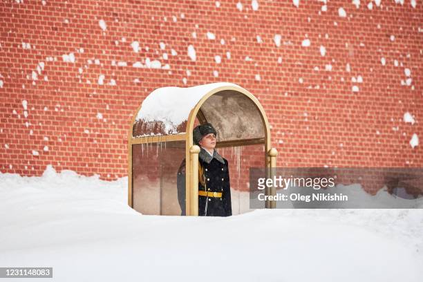 Russian honour guard stands between snowdrifts while on duty at the Tomb of the Unknown Soldier by the Kremlin wall during a heavy snowfall on...