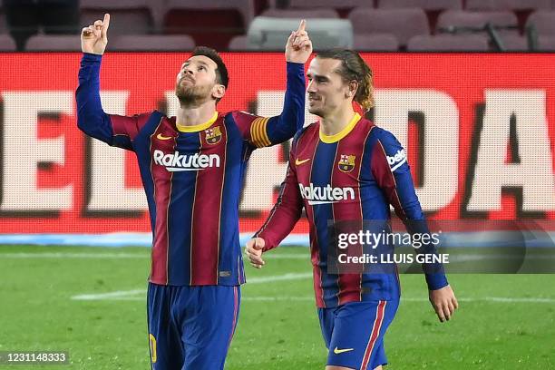 Barcelona's Argentinian forward Lionel Messi celebrates with Barcelona's French midfielder Antoine Griezmann after scoring a goal during the Spanish...