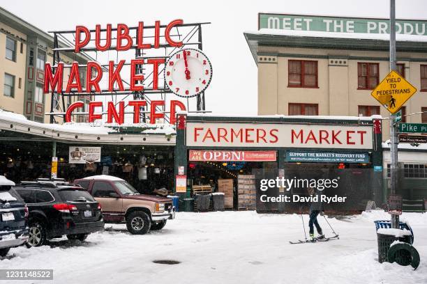 Harrison Walsh skis by Pike Place Market on February 13, 2021 in Seattle, Washington. A large winter storm dropped heavy snow across the region.