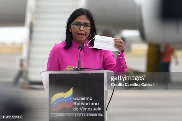 Vice President of Venezuela Delcy Rodriguez holds a protective mask as she addresses the media as the first batch of 100,000 doses of coronavirus...