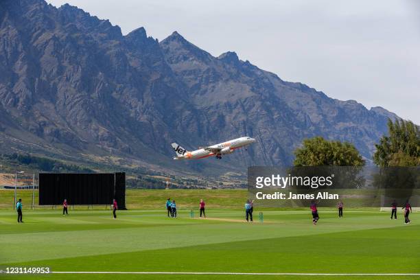 View of the Remarkables with a Jetstar plane taking off during the Tour Match between the New Zealand XI and England on February 14, 2021 in...