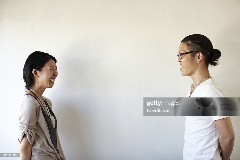 Young couple smiling at each other, side view