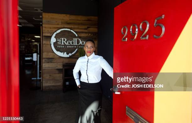 Reign Free, Founder and CEO of The Red Door Group catering company, stands for a photo at her office in Oakland, California on February 12, 2021. -...