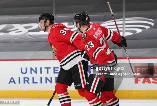 Carl Soderberg of the Chicago Blackhawks celebrates with Philipp Kurashev of the Chicago Blackhawks after scoring against the Columbus Blue Jackets...