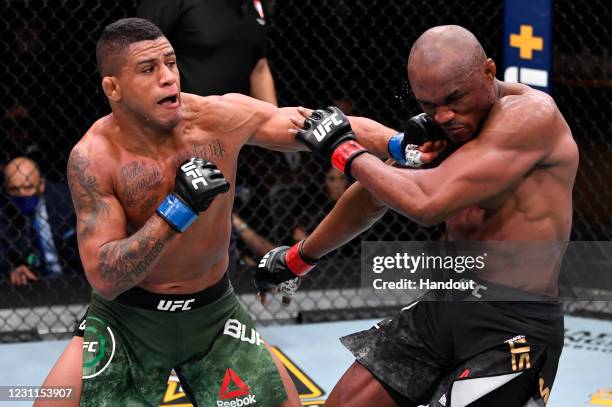 In this handout image provided by UFC, Gilbert Burns of Brazil punches Kamaru Usman of Nigeria in their UFC welterweight championship fight during...