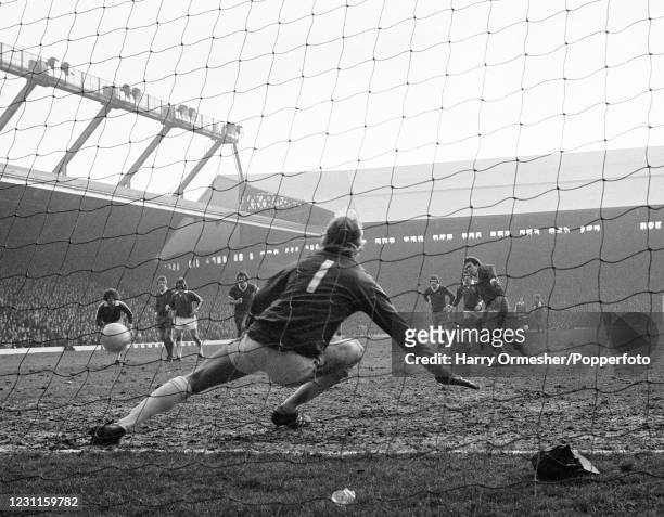 Phil Neal of Liverpool scores a penalty past Oldham Athletic goalkeeper John Platt during an FA Cup 5th Round tie at Anfield on February 26, 1977 in...