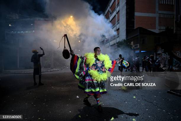 Member of a traditional Bate-Bola group, an annual cultural festivity which takes place during the carnival period, celebrates at the street in a...