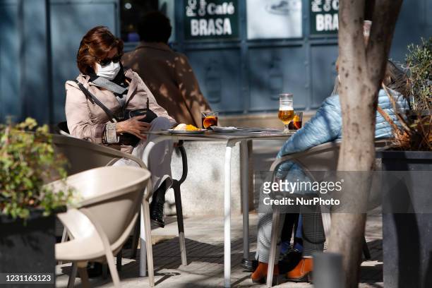 Woman has a drink in a bar during a sunny and warm Valentine's Day on February 14, 2021 in Granada, Spain. Granada, a province of Andalusia in Spain,...