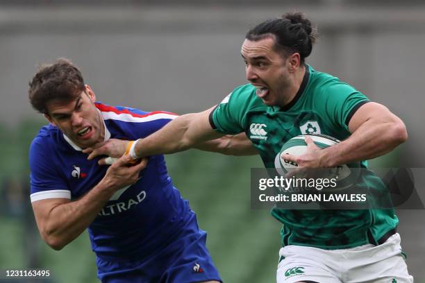 Ireland's wing James Lowe hands-off France's wing Damian Penaud during the Six Nations international rugby union match between Ireland and France at...