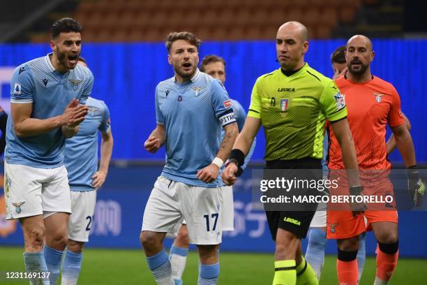 Lazio's Dutch defender Wesley Hoedt and Lazio's Italian forward Ciro Immobile protest after Italian referee Michael Fabbri granted a penalty to Inter...