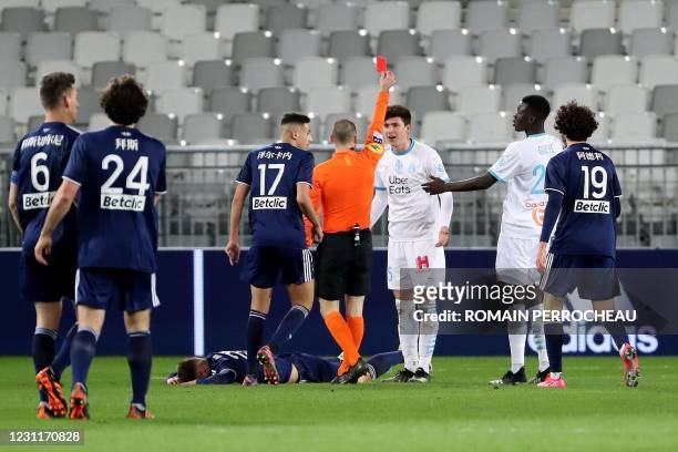 Marseille's Argentine defender Leonardo Balerdi is shown a red card during the French L1 football match between FC Girondins de Bordeaux and...