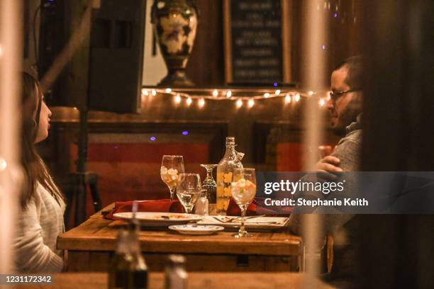 Couple have dinner inside a restaurant on Valentine's Day on February 14, 2021 in the Little Italy neighborhood in New York City. New York City...