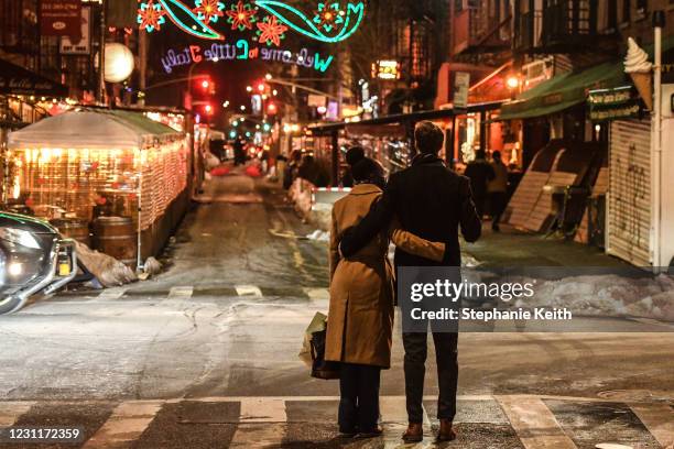 Couple waits to cross the street on Valentine's Day on February 14, 2021 in the Little Italy neighborhood in New York City. Despite the ongoing...