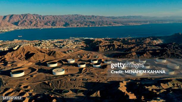 This picture taken on February 10, 2021 shows an aerial view of oil storage containers of the Eilat Ashkelon Pipeline Company in the mountains near...