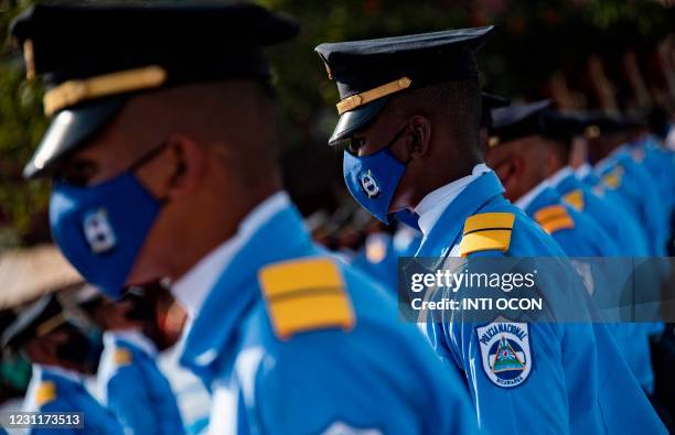 National Police cadets wearing face masks as a preventive measure against the spread of the novel coronavirus, COVID-19, take part in a mass wedding...