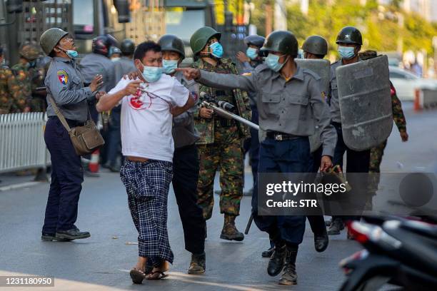 Police arrest a protester demonstrating against the military coup in Mandalay on February 15, 2021.