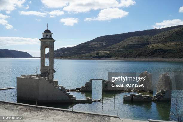Photo taken on February 14, 2021 shows the ruins of the abandoned Saint Nicholas church partially submerged in water in the Kouris Dam which was...