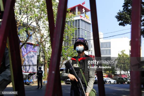 Riot polices stand to provide security near the headquarters of National League for Democracy Party Monday, February 15 in Yangon, Myanmar.