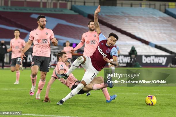 Chris Basham of Sheffield United fouls Jesse Lingard of West Ham United to give away a penalty during the Premier League match between West Ham...