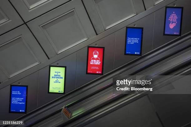 Social distancing guidelines on electronic signs on the London Underground in the City of London, U.K., on Monday, Feb. 15, 2021. The U.K. Recorded...