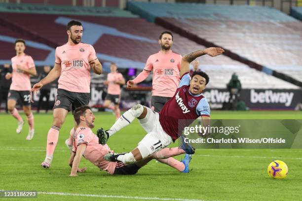 Chris Basham of Sheffield United fouls Jesse Lingard of West Ham United to give away a penalty during the Premier League match between West Ham...