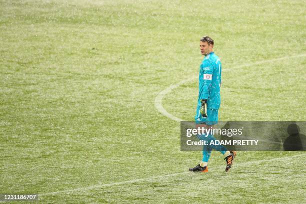 Bayern Munich's German goalkeeper Manuel Neuer stands in the snow during the German first division Bundesliga football match FC Bayern Munich v DSC...