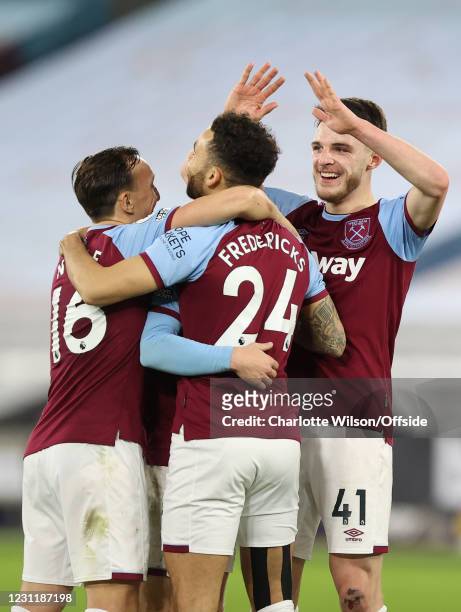 Mark Noble and Declan Rice celebrate with Ryan Fredericks of West Ham United after he scores their 3rd goal during the Premier League match between...