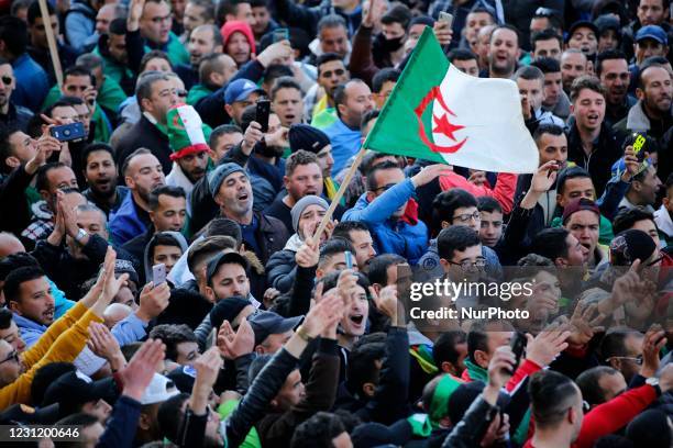 Protesters carry flags as they gather in the town of Kherrata, marking the second anniversary of the start of a mass protest movement in that country...