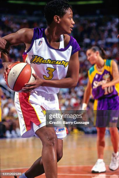 June 01: Tia Jackson of the Phoenix Mercury handles the ball agains the Los Angeles Sparks on June 1, 1997 at America West Arena in Phoenix, Arizona....