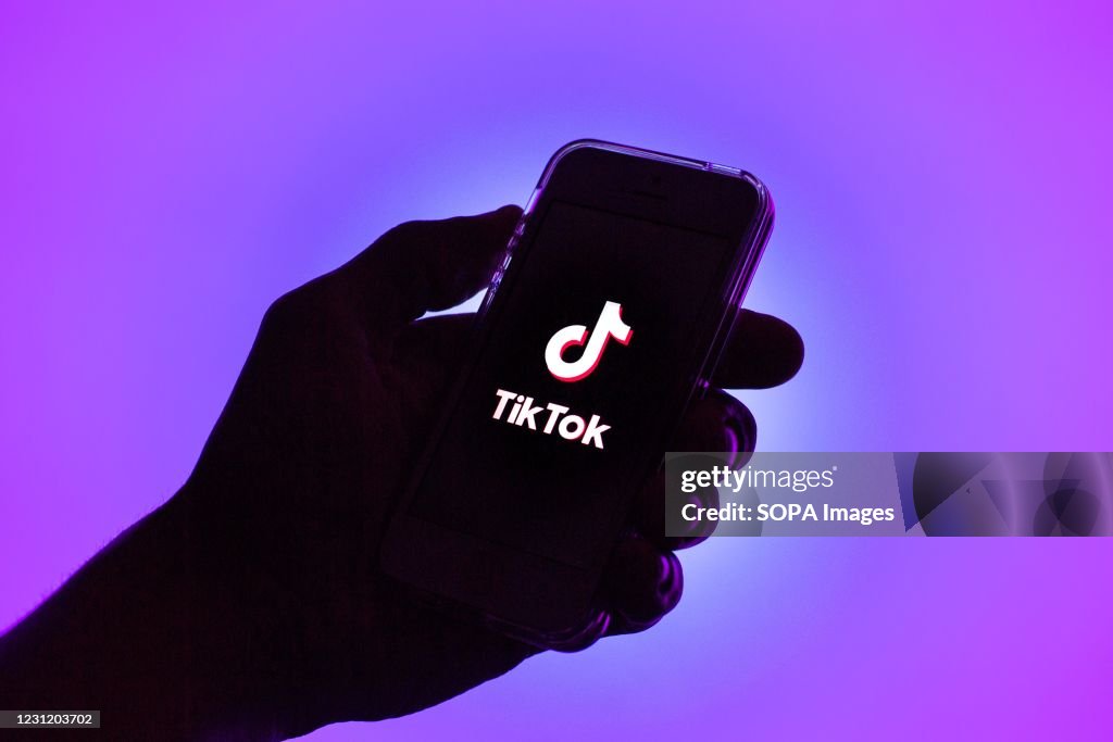 In this photo illustration, a Tik Tok logo seen displayed on...