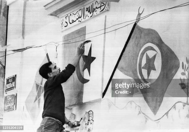 An Algerian member of the FLN sets up Algerian flags on June 29, 1962 in the Kasbah of Algiers before the referendum on self-determination of...
