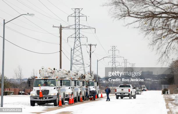 Pike Electric service trucks line up after a snow storm on February 16, 2021 in Fort Worth, Texas. Winter storm Uri has brought historic cold weather...