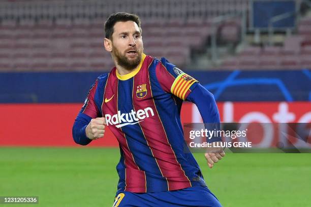 Barcelona's Argentinian forward Lionel Messi celebrates after scoring a goal during the UEFA Champions League round of 16 first leg football match...