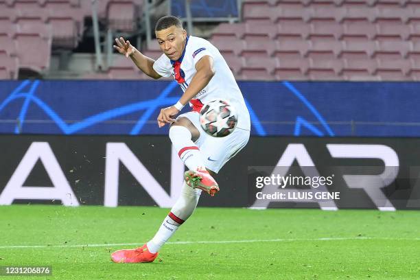 Paris Saint-Germain's French forward Kylian Mbappe scores a goal during the UEFA Champions League round of 16 first leg football match between FC...