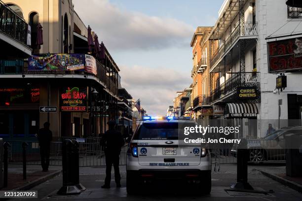 An NOPD officer stands on an empty Bourbon Street during Mardi Gras on February 16, 2021 in New Orleans, Louisiana. Traditional Mardi Gras...